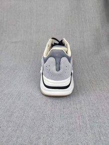 700 Grey Lifestyle Sneakers with Orange Accents