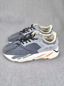 700 Grey Lifestyle Sneakers with Orange Accents
