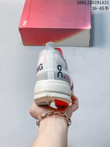 On Cloudboom Strike Running Shoes in Coral and Lilac